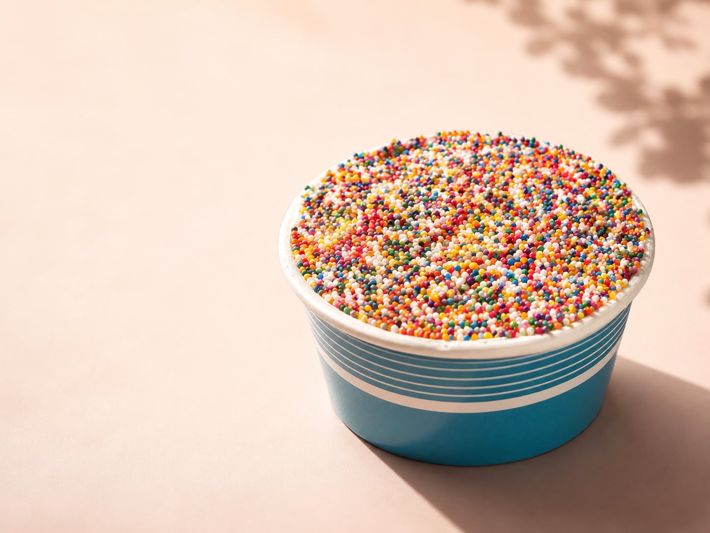 The viral Sprinkle Cake — cake-in-a-cup topped with a crunchy coating of rainbow nonpareil sprinkles